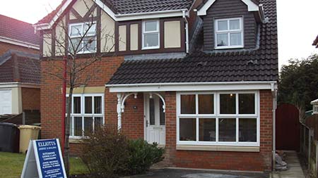 Picture of a finished garage conversion with porch.