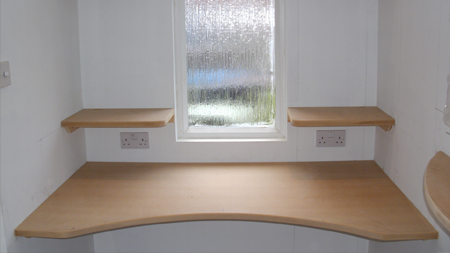 Picture of an office with shelves and plug sockets.